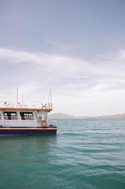Ferry boat cruising on serene turquoise sea beneath a clear sky.